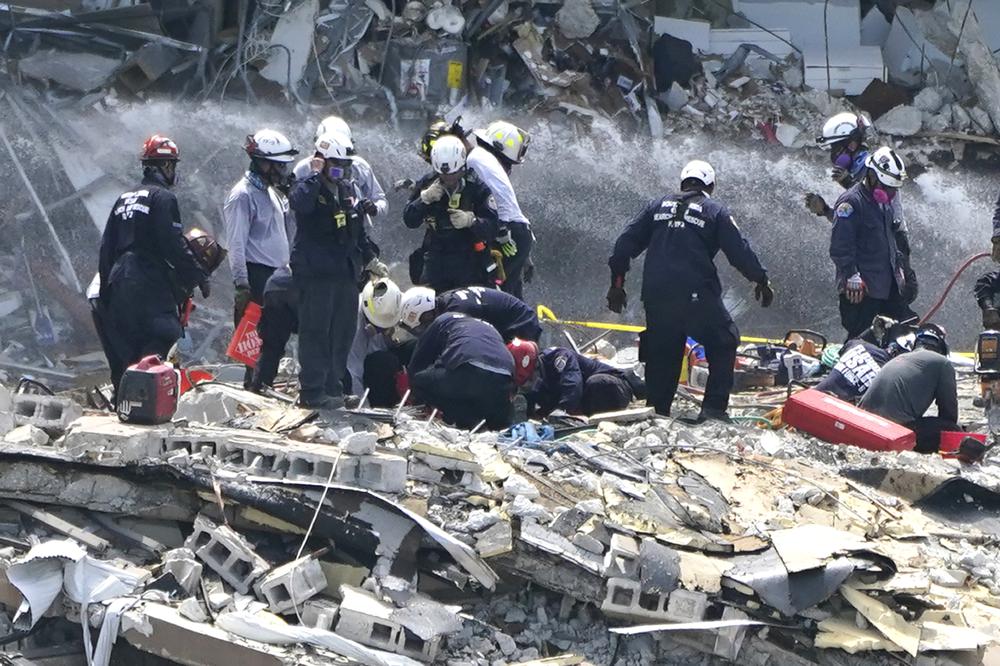 Rescue workers search the rubble of the Champlain Towers South condominium, Saturday, June 26, 2021, in the Surfside area of Miami. The building partially collapsed on Thursday. (AP Photo/Lynne Sladky)